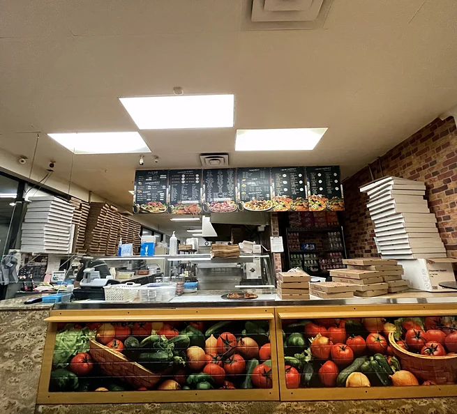 Pizza counter and menu boards at Lava Pizza & Wings on Fennell