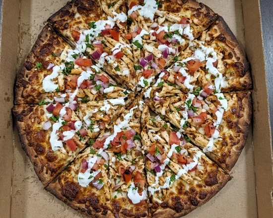 Chicken shawarma pizza with tomato, red onion, parsley and garlic sauce drizzle